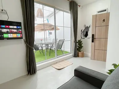 a living room with a couch and a table at Relax Private terrace&cozy BR,near Grand palace in Bangkok