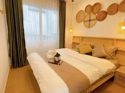 a bedroom with a large bed with a window at Relax Private terrace&cozy BR,near Grand palace in Bangkok