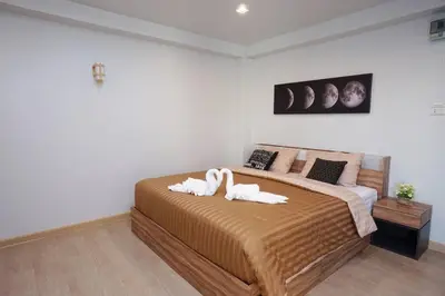 a bedroom with a large bed with towels on it at Maruay Living Apartment 510 (Khaosan/Chinatown/Samyot MRT) in Bangkok