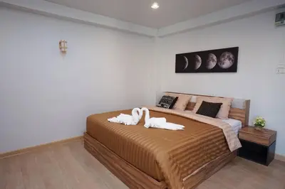 a bedroom with a large bed with towels on it at Maruay Living Apartment 510 (Khaosan/Chinatown/Samyot MRT) in Bangkok