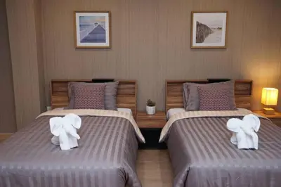 two beds with stuffed elephants on them in a bedroom at Maruay Living Apartment 509 (Khaosan/Chinatown/Samyot MRT) in Bangkok