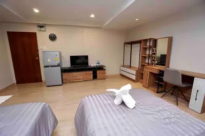 a bedroom with a bed with a white animal on it at Maruay Living Apartment 509 (Khaosan/Chinatown/Samyot MRT) in Bangkok