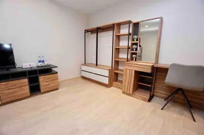 a room with a desk and a chair and a television at Maruay Living Apartment 509 (Khaosan/Chinatown/Samyot MRT) in Bangkok