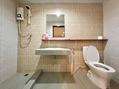 a bathroom with a toilet and a sink and a mirror at Maruay Living Apartment 501 (Khaosan/Chinatown/Samyot MRT) in Bangkok