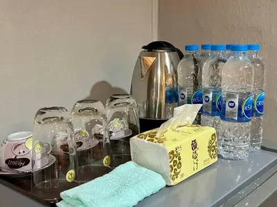 a counter with glasses and bottles of water on it at Maruay Living Apartment 501 (Khaosan/Chinatown/Samyot MRT) in Bangkok