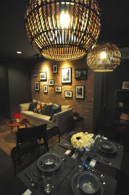 a living room with a table and a large chandelier at Tuk Tuk House 250m from MRT Sirikit in Bangkok