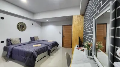 a bedroom with a bed and a fireplace at Irich residence South Samrong 6 Kms BTS-Pu Chao in Samut Prakan