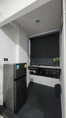 a kitchen with a refrigerator and a large window at Irich residence South Samrong 6 Kms BTS-Pu Chao in Samut Prakan