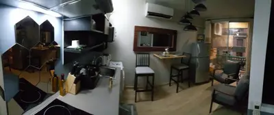 a small kitchen with a counter and a sink in a room at The Parkland Condominium in Bangkok