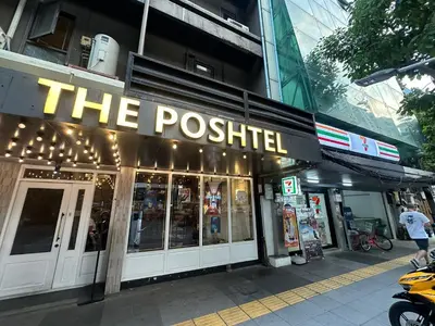 a restaurant with the posted sign on the side of a building at The poshtel Bangkok By Benya BTS Phayathai in Bangkok