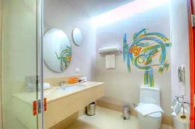 a bathroom with a sink and a toilet and a mirror at One One Bangkok in Bangkok