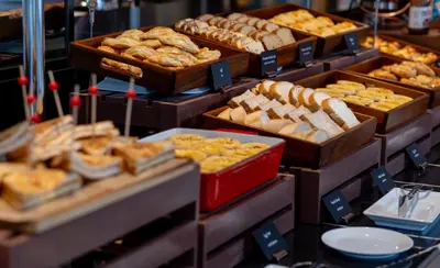 a display of different types of bread and pastries at Grande Centre Point Surawong Bangkok in Bangkok