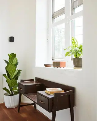 a room with a bench and a window with plants at Motu Bangkok in Bangkok