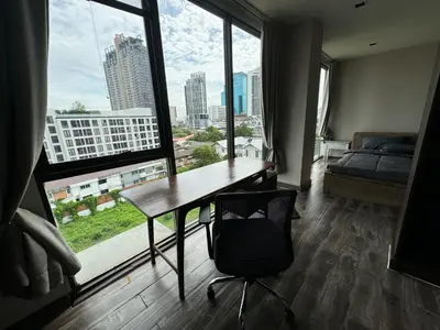 a room with a desk and a large window at W8 CONDO, TOP Floor LUXE 3 Bedroom Penthouse, Hip central Bangkok area, 5 mins from Thonglo BTS station in Bangkok