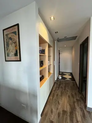 an empty hallway with a painting on the wall and a painting on the wall at W8 CONDO, TOP Floor LUXE 3 Bedroom Penthouse, Hip central Bangkok area, 5 mins from Thonglo BTS station in Bangkok
