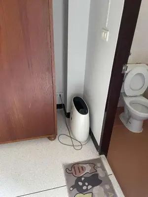 a bathroom with a toilet and a rug on the floor at Viriyapon2 in Bangkok