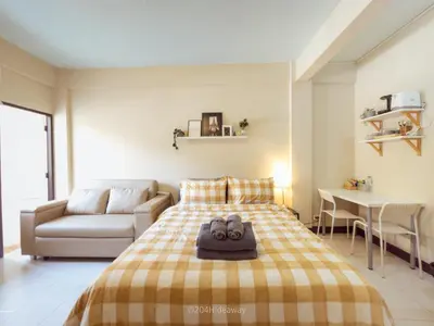 a bedroom with a bed and a couch and a table at 204hideaway-Local Room with Street Food only 15 min walk to Skytrain in Bangkok