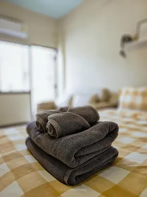 a pile of towels sitting on top of a floor at 204hideaway-Local Room with Street Food only 15 min walk to Skytrain in Bangkok