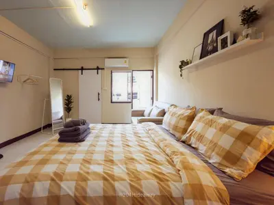 a bedroom with a large bed and a couch at 204hideaway-Local Room with Street Food only 15 min walk to Skytrain in Bangkok