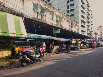 a motorcycle parked on the side of a city street at 204hideaway-Local Room with Street Food only 15 min walk to Skytrain in Bangkok