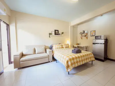 a bedroom with a bed and a couch and a table at 204hideaway-Local Room with Street Food only 15 min walk to Skytrain in Bangkok