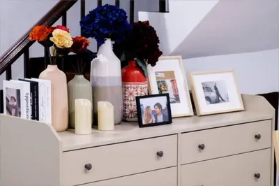 a white dresser with vases and pictures on it at Spacious 4BRTownhouse BTS Onnut 10 Sleeps with Parking in Amphoe Phra Khanong