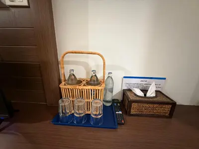 a basket with glasses and a bottle and a box at Bed By Cruise Hotel At Samakkhi-Tivanont in Nonthaburi