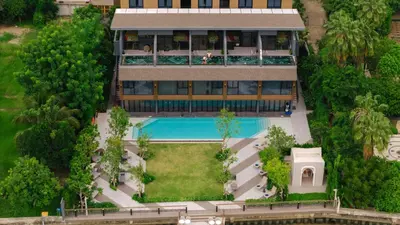 an aerial view of a house with a swimming pool at Ten Six Hundred, Chao Phraya, Bangkok by Preference, managed by The Ascott Limited in Bangkok