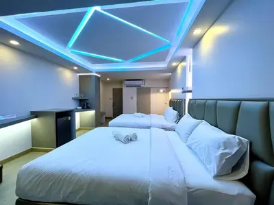 a bedroom with a large white bed with a blue ceiling at DiscoveryHome3 at Pratunammarket in Bangkok