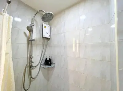 a shower with a shower head in a bathroom at DiscoveryHome3 at Pratunammarket in Bangkok