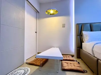 a small room with a bed and a table at DiscoveryHome3 at Pratunammarket in Bangkok