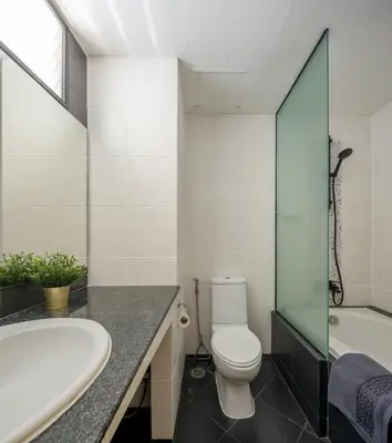 a bathroom with a toilet and a sink and a tub at AndStay in Bangkok
