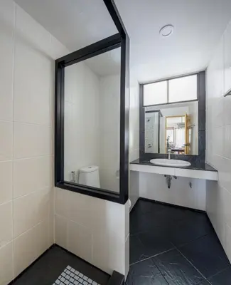 a bathroom with a mirror and a sink at AndStay in Bangkok