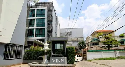 a building with a sign in front of it at Vinn condo in Amphoe Phra Khanong