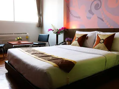 a bedroom with a large bed in a room at Happyland Mansion in Bangkok
