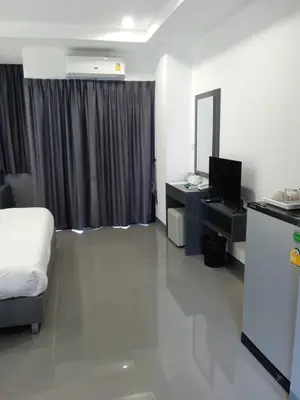 a hotel room with a bed and a television at D Night Suite Hotel in Bangkok
