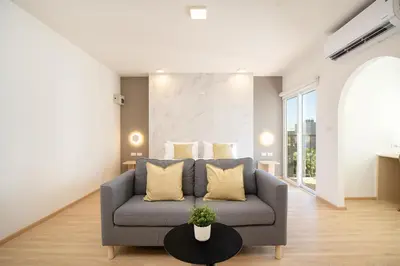 a living room with a couch and a table at Diya Hotel Bangkok in Amphoe Phra Khanong