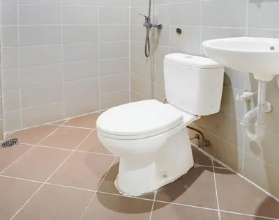 a bathroom with a toilet and a sink at OYO 75446 Travis Inthamara 49 in Bangkok