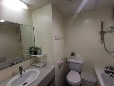 a bathroom with a sink and a toilet and a mirror at Tower Resident in the Heart of Bangkok Shopping Center in Makkasan