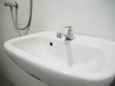 a white sink in a bathroom with a shower at NANA BEST INN HOTEL in Makkasan