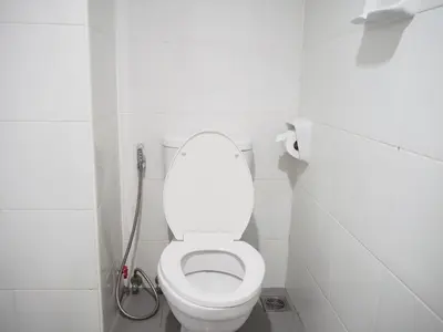 a white toilet in a bathroom with a shower at NANA BEST INN HOTEL in Makkasan