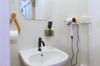 a bathroom with a sink and a hair dryer on the wall at Getaway Villa Bangkok - 4 Bedroom,6 Beds and 5 Bathroom in Bangkok