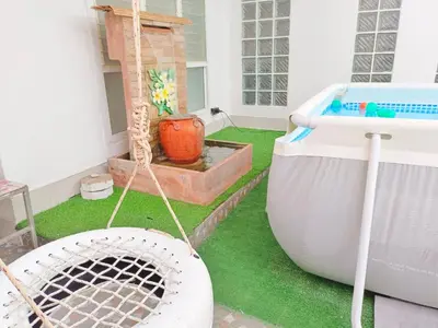 a backyard with a pool and a tub and grass at Getaway Villa Bangkok - 4 Bedroom,6 Beds and 5 Bathroom in Bangkok