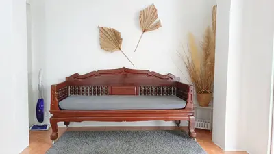 a wooden bench with a cushion on it in a room at Getaway Villa Bangkok - 4 Bedroom,6 Beds and 5 Bathroom in Bangkok