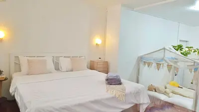 a bedroom with a large white bed and a window at Getaway Villa Bangkok - 4 Bedroom,6 Beds and 5 Bathroom in Bangkok