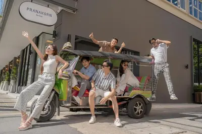 a group of people sitting in the back of a golf cart at Pranakorn Heritage Hotel in Bangkok