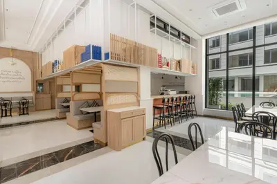 a room with a table and chairs and a building at Pranakorn Heritage Hotel in Bangkok