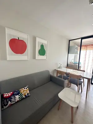 a living room with a gray couch and a table at N Condominium in Ban Bang Khen (1)