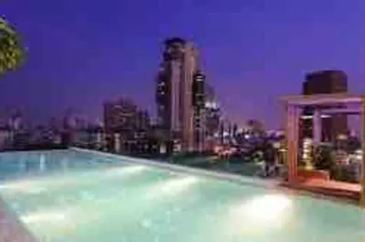 a large swimming pool on top of a city skyline at 2BedRoom-BestLocationBangkok-Emquartier-Metro-PhromPhong in Bangkok