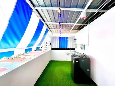 a room with a green floor and a suitcase at k4 be chill *Wongwianyai BTS_80m*Family&Friend* in Godown